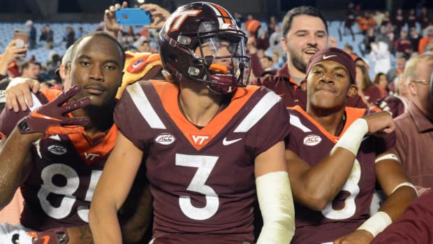 Virginia Tech Hokies defensive back Caleb Farley (3) tight end Chris Cunningham (85) and wide receiver Phil Patterson (8) celebrate with fans after a win against the North Carolina Tar Heels at Kenan Memorial Stadium. The Hokies won 22-19.